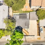 Aerial view of California homes with driveways and green trees