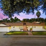 California real estate house with front yard, driveway, chimney, and trees