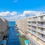 View of marina with water, boats, and buildings
