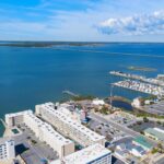 Aerial view of water, bridge, homes, and small boats