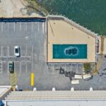 Aerial view of water, bridge, homes, and small boats